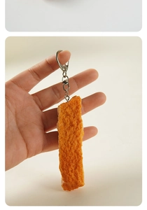 Macro detail of realistic fried chicken keychain with crispy texture and metal clasp