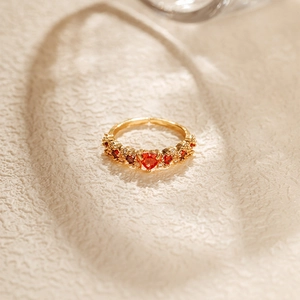 Macro shot of 18K gold plated ring featuring a red heart zircon with crystal accents