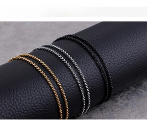 Detailed view of stainless steel chain necklaces in gold, silver, and gun black finishes