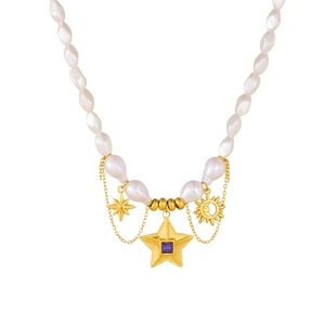 Baroque pearl necklace with gold star pendant and purple gemstone on white background