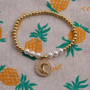 Gold-plated beaded bracelet with pearls and a crescent moon zircon charm