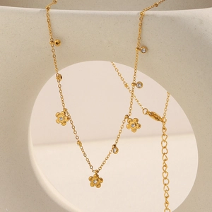 Detail view of 18K gold plated flower fringe necklace with sparkling zircon stones