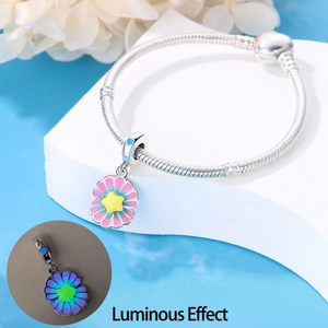 Luminous sunflower charm with pink and blue petals on silver snake chain bracelet