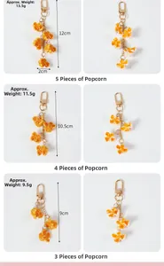 Detailed comparison of three sizes of realistic PVC popcorn keychain with golden clasp