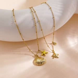 Detailed view of ocean theme shell and starfish pendants on 14K gold-plated chains
