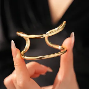 Minimalist double-layered gold open cuff bracelet with a polished hollow metal design