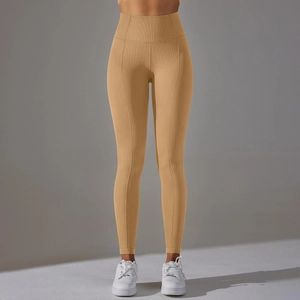 Detail showing high-waisted ginger yoga leggings with a honeycomb textured fabric texture