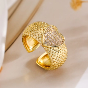 Detailed close-up of a 18K gold-plated heart ring with pavé zircons and woven texture