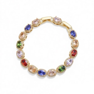 Vintage gold tone bracelet featuring oval multi-colored gemstones and zircon accents
