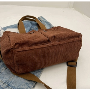 Detail view of the durable corduroy shoulder bag base showing large capacity and texture
