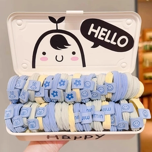 Detailed set of blue and yellow elastic hair ties in a white metal Hello storage box