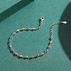 Elegant S925 sterling silver bracelet featuring colorful zircon stones on green background
