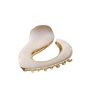 Elegant cream resin hair claw clip with irregular wavy design and golden metal teeth