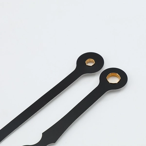 Matte black quartz clock hands with gold metal inserts on a clean white background