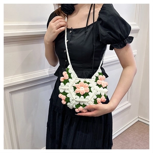 Handmade 3D puff flower crochet crossbody bag worn by model on black dress