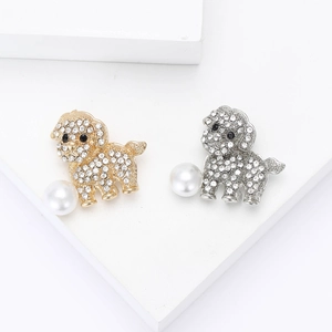 Chic dog brooches with rhinestones and pearls in gold and silver finish on display