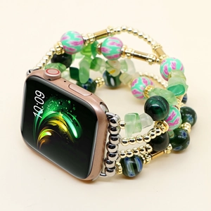 Detail view of multi-layer beaded strap for smartwatch with green floral and gold accents