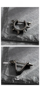 Macro display of black stainless steel spike earrings and V-shaped punk studs