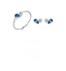 Macro detail of S925 sterling silver set with blue water-drop gemstone and white diamond