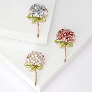 Detail view of colorful hydrangea enamel brooches with crystals on gold alloy base