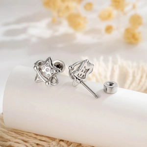 Minimalist silver star earrings with zircon inlay and screw back closure detail