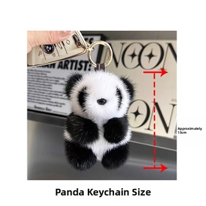 Detail shot showing a 13cm fluffy panda plush keychain with a gold ring attachment