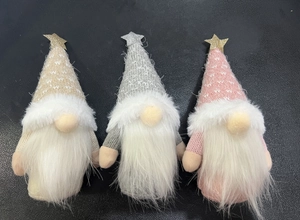 Close-up of three knitted Christmas gnomes with golden stars in beige, grey, and pink
