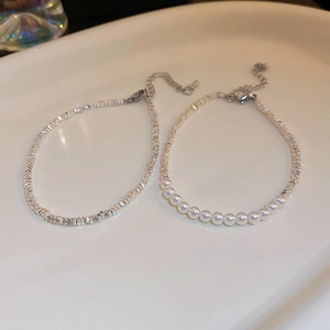 Detail showing irregular silver beads and white pearl beaded bracelets with lobster clasp
