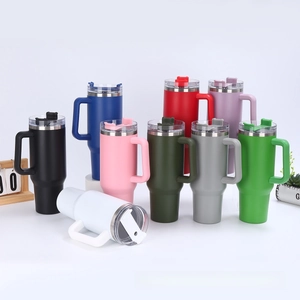 Macro shot of 40oz stainless steel tumblers with ergonomic handles in nine vibrant colors