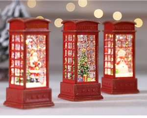 Detail of red Christmas telephone booth LED snow globes with Santa, snowman and tree