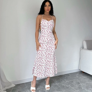 Floral halter backless dress featuring a thigh-high slit and vibrant purple flower patterns
