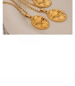 Detailed macro view of vintage gold-plated oval pendant necklace with embossed figure detail