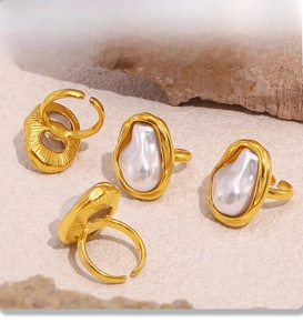 Detail of PVD electroplated gold rings with irregular baroque pearls and textured edges