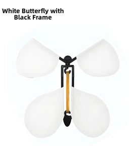 Close-up of flying magic butterfly toy with white wings and black plastic frame
