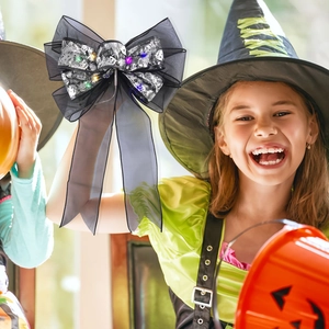Detailed black mesh Halloween bow with silver skulls and glowing colorful LED lights