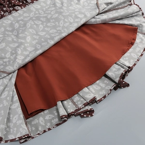 Detail of floral chiffon fabric and solid lining showing hem stitching and texture