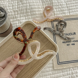 Elegant cellulose acetate hair claw clips with minimalist twist design and metal clasp