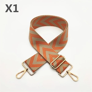 Macro view of wide woven strap with orange chevron pattern and gold metal hooks