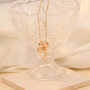 Macro shot of gold three-petal flower pendant with amber glass and zircon crystals