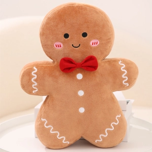 Peluche bonhomme en pain d'épices marron avec nœud rouge et détails givrés