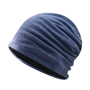 Detail showing soft dark blue pleated knit fabric and thick black thermal lining of the beanie