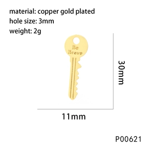 Detailed view of a gold plated copper key pendant with Be Brave engraving and dimensions