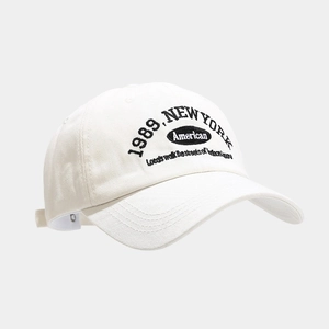 Detail of vintage 1989 New York embroidery on a beige cotton baseball cap for adults