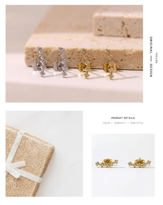 Macro detail of elegant curved gold and silver stud earrings with zircon inlays