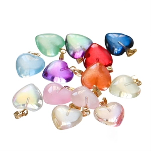 Macro view of assorted acrylic heart charms with gold loops for DIY jewelry making