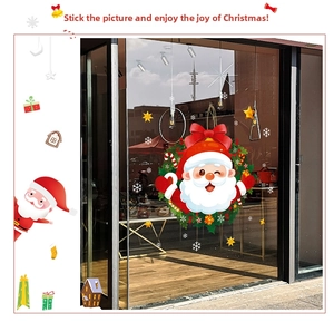 Detail of Christmas Santa wreath window sticker with snowflakes and stars on glass