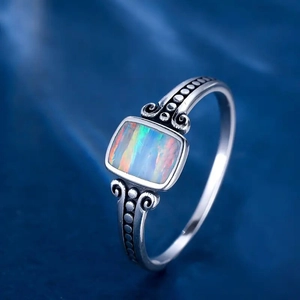 Macro detail of rectangle opal ring with vintage engraved patterns and antique silver finish