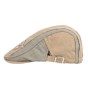 Detail view of khaki and green patchwork flat cap with frayed edges and metal buckle