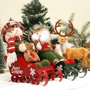 Christmas sleigh decoration featuring Santa and snowman figures in a snowy festive scene