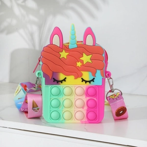 Detail of colorful gradient unicorn silicone pop bag with rainbow strap on marble surface